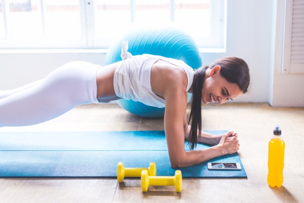 A woman is doing physical exercise i.e. Muscle bulding and it will help her fight anxiety