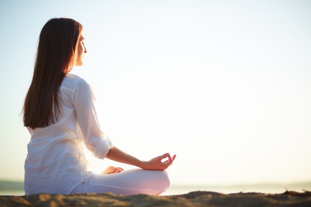 A woman is doing physical exercise i.e. Yoga and it will help her fight anxiety